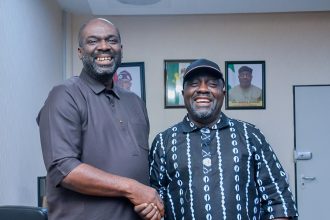 Bukola Olopade in handshake with Malik Ikpokpo