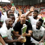 Super Eagles players celebrating Unity cup trophy