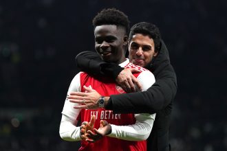 Saka and Arteta smiling