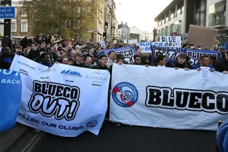 Chelsea fans with 'BlueCo Out' banners