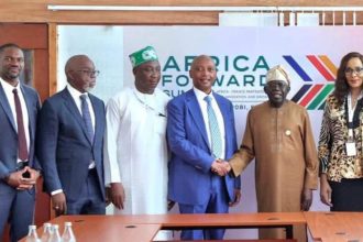 President Bola Tinubu in handshake with CAF president, Patrice Motsepe